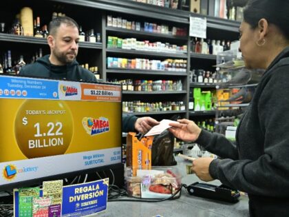 A person purchases their Mega Millions lottery ticket from a liquor store where winning ti