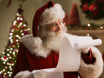 Santa Claus with checklist, portrait, close-up - stock photo