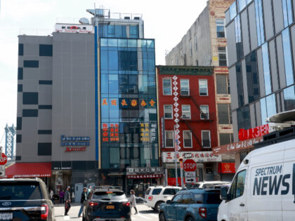 Real estate of building located at 107 East Broadway in Chinatown (blue building). Lu Jian