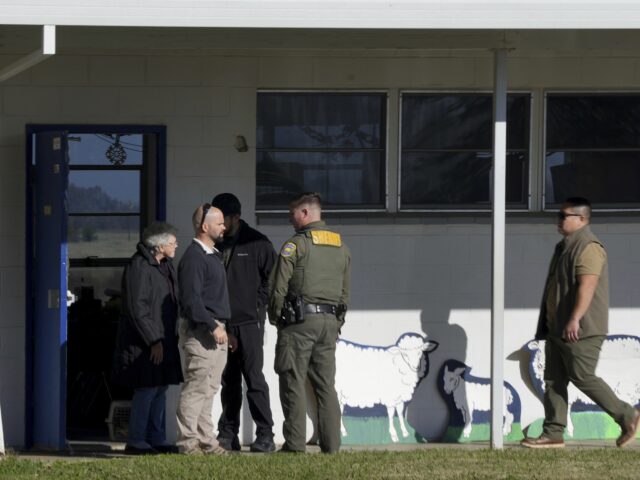 School officials and Sheriff's deputies gather outside Feather River Adventist School