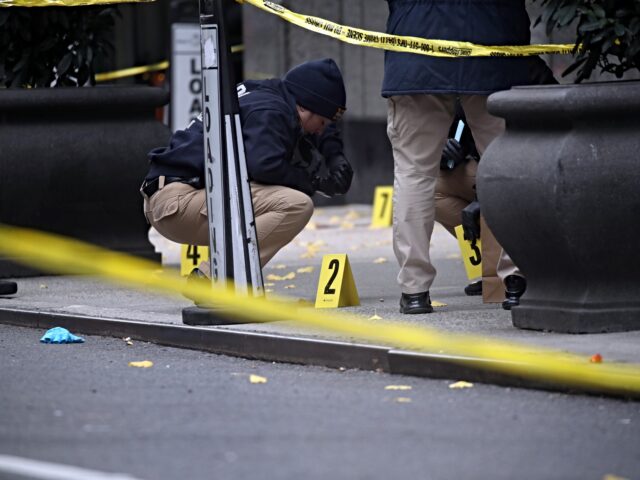 NEW YORK, NEW YORK - DECEMBER 04: Police place bullet casing markers outside of a Hilton H