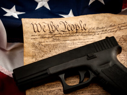 The second amendment and gun control in america concept with a handgun and the american co