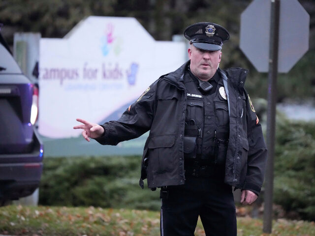 A police officer directs traffic as emergency vehicles are parked outside the Abundant Lif