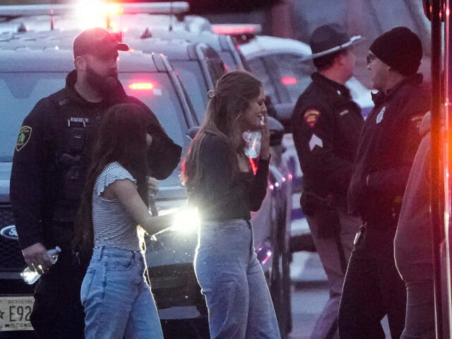 Students board a bus as they leave the shelter following a shooting at the Abundant Life C