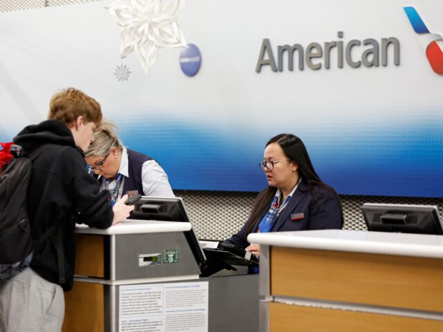 American Airlines agent assists a traveler at O'Hare International Airport in Chicago, Ill