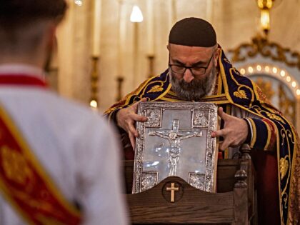 A priest leads the Christmas morning mass at the Syriac Orthodox Church of Virgin Mary in