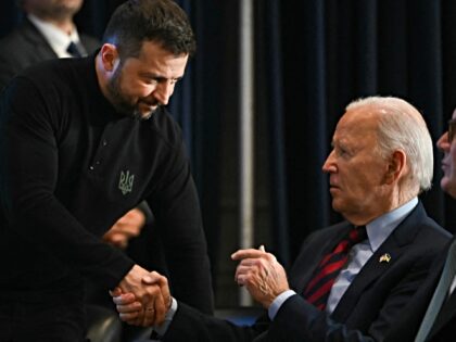 (L-R) Ukrainian President Volodymyr Zelensky shakes hands with US President Joe Biden duri