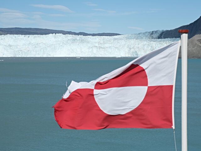 EQIP SERMIA, GREENLAND - JULY 31: A Greenlandic flag flies near the Eqip Sermia glacier, a