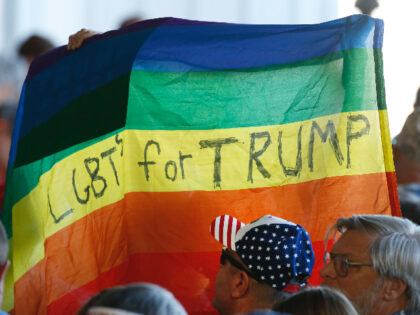 GRAND JUNCTION, CO - OCTOBER 18: Supporters hold up a gay pride flag for Republican presid