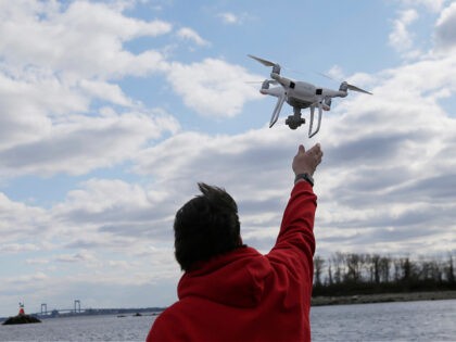 FILE - In this April 29, 2018, file photo, a drone operator helps to retrieve a drone afte