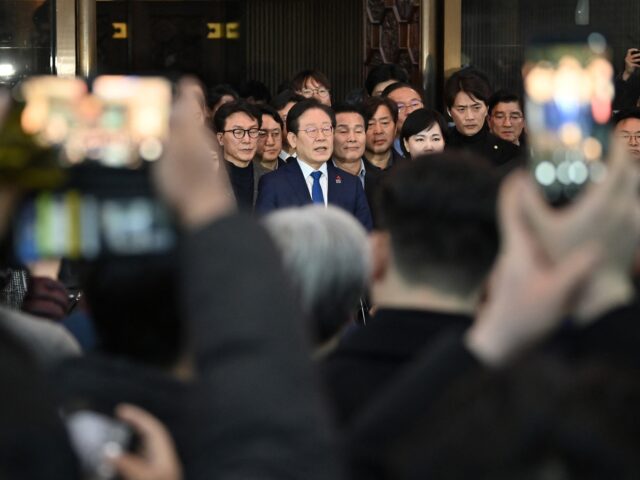 South Korea's main opposition Democratic Party leader Lee Jae-myung (C) speaks to the medi