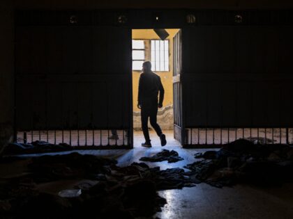 A Syrian man walks out of a cell in the prison of Saydnaya, north of Damascus on December