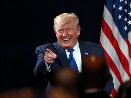 President Donald Trump points to supporters after speaking at his Black Voices for Trump r