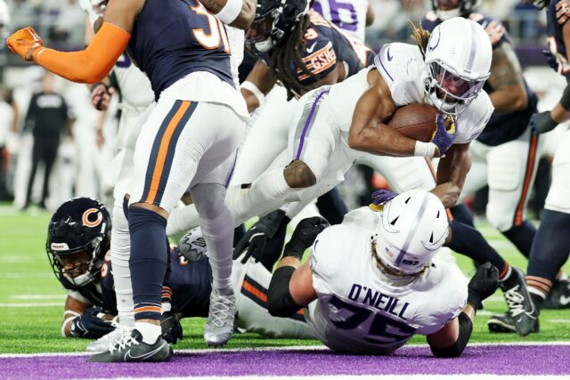 Aaron Jones of the Minnesota Vikings scores a third quarter touchdown in the Vikings' NFL