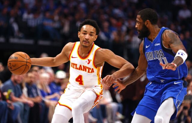 Atlanta Hawks guard Kobe Bufkin, at left driving past Kyrie Irving of Dallas, will miss th