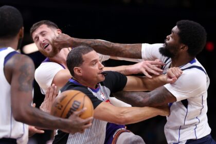 Dallas's Naji Marshall punches Jusuf Nurkic of the Phoenix Suns during the second half of