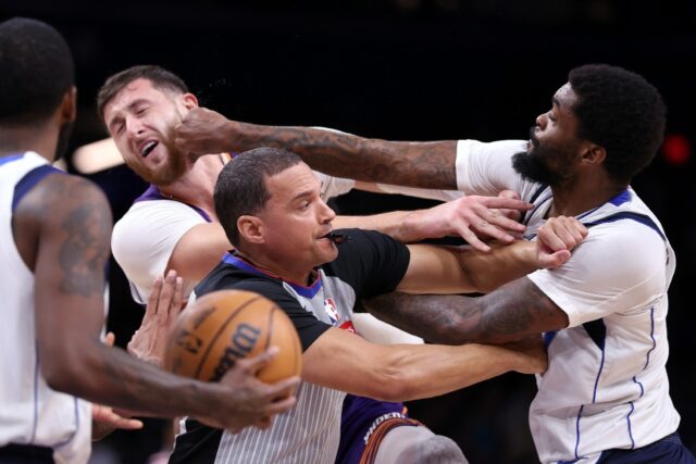 Dallas's Naji Marshall punches Jusuf Nurkic of the Phoenix Suns during the second half of