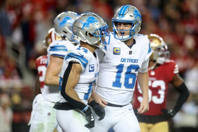 Detroit's Jared Goff, right, celebrates a touchdown pass with teammates as the Lions impro