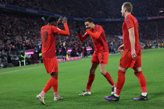 In the goals: Alphonso Davies (L) celebrates his goal with Jamal Musiala and Harry Kane