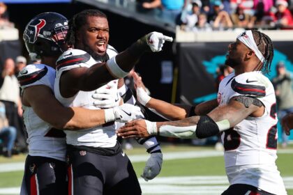 Houston Texans linebacker Azeez Al-Shaair is restrained after being ejected from an NFL ga