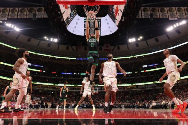 Jayson Tatum of the Boston Celtics throws down a dunk in the Celtics' NBA victory over the