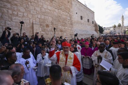 Latin Patriarch of Jerusalem Pierbattista Pizzaballa leads a Christmas procession outside