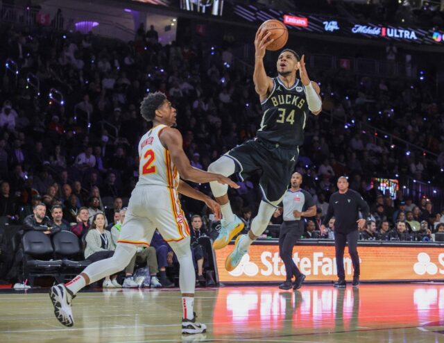 Milwaukee's Giannis Antetokounmpo scores a layup against Atlanta's Keaton Wallace, two of