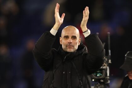 Pep Guardiola applauds Manchester City's fans after a 2-0 win at Leicester