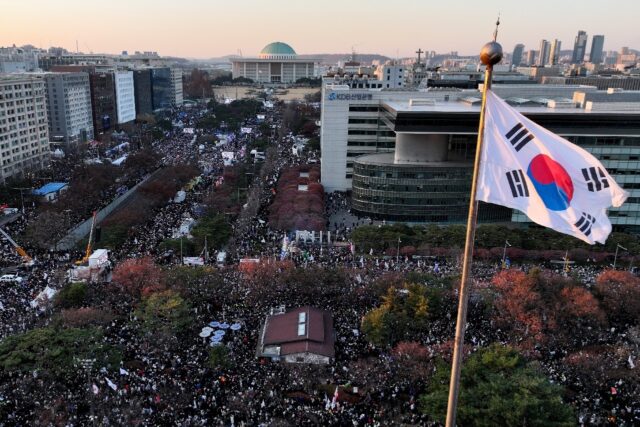 Protesters calling for the ouster of President Yoon Suk Yeol celebrate after the impeachme