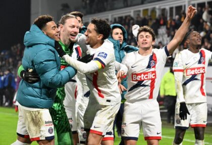 PSG players celebrate with goalkeeper Matvey Safonov after he helped them beat Lens on pen