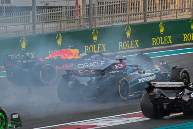 Red Bull's Max Verstappen (L) drives on after his collision with Oscar Piastri in Abu Dhab
