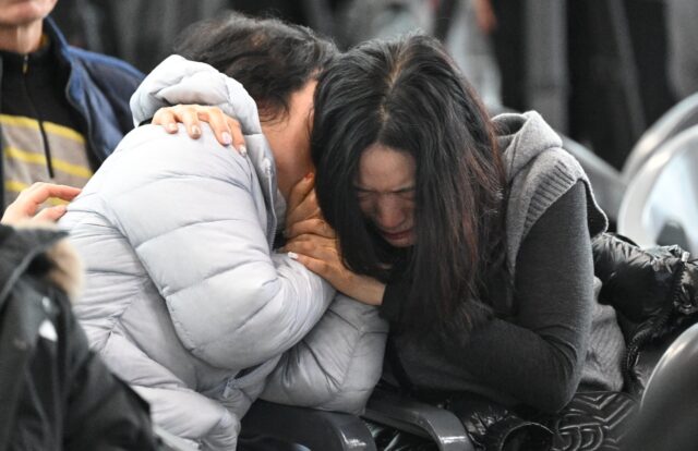 Relatives of passengers on the doomed Jeju Air planecomfort each other at Muan Internation