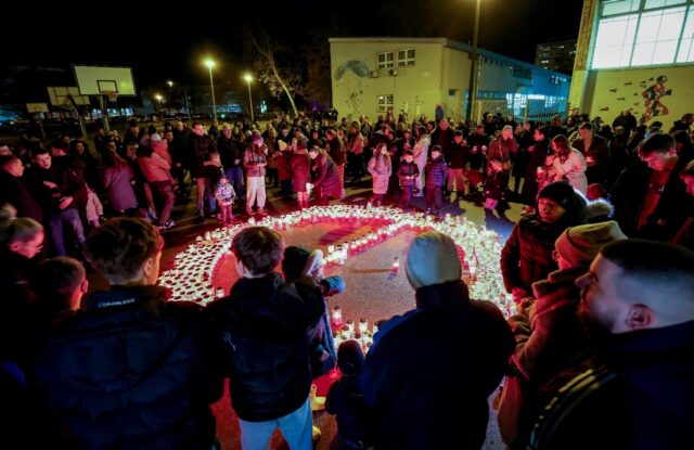 Residents have been lighting candles and leaving messages of condolences near the school w