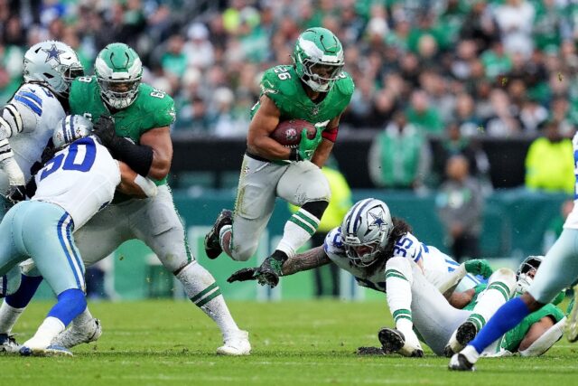 Saquon Barkley of the Philadelphia Eagles jumps over the tackle of the Dallas Cowboys' Mar