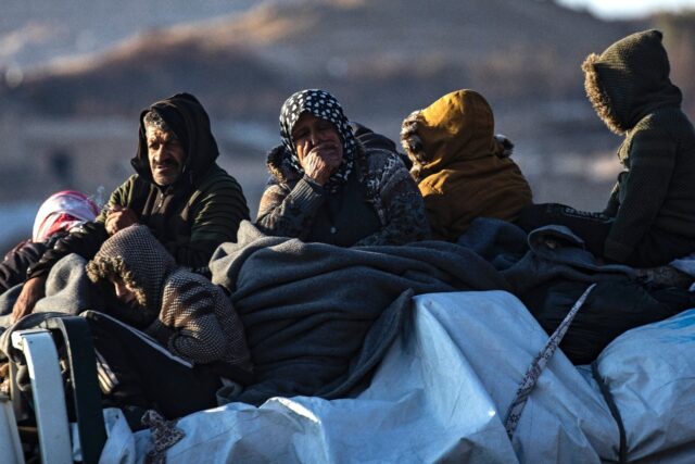 Syrian Kurds flee with what belongings they can carry after Islamist-led rebels overran th