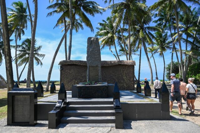 Tourists visit the memorial monument to commemorate the victims of the 2004 tsunami, in Pe
