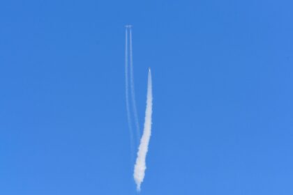 The Virgin Galactic SpaceShipTwo space plane Unity and mothership flies above Spaceport Am