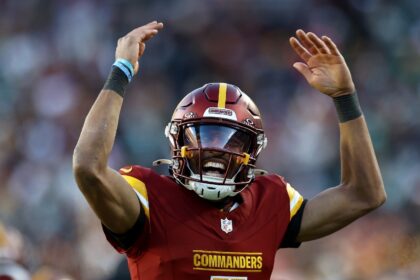 Washington quarterback Jayden Daniels celebrates a touchdown pass in the Commanders' NFL v