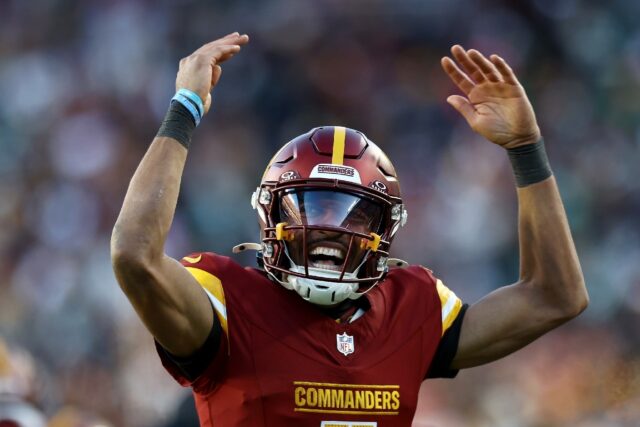 Washington quarterback Jayden Daniels celebrates a touchdown pass in the Commanders' NFL v