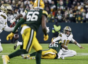 Josh Jacobs, defense help Packers roll over Saints, clinch playoff spot