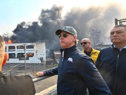 PCIFIC PALISADES, CA - January 08: California Governor Gavin Newsom, left, surveys damage