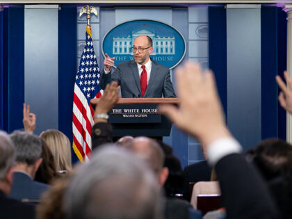 Reporters raise their hands to ask a question of Acting Director of the Office of Manageme