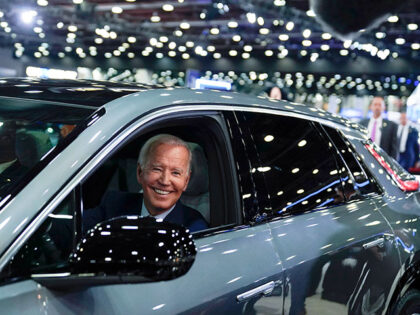 President Joe Biden drives a Cadillac Lyriq through the showroom during a tour at the Detr