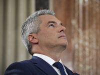 Austrian Chancellor Karl Nehammer looks up while attending a debate at the national broadc