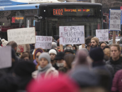 People stopping traffic stand in silence to commemorate the 15 victims killed after a rail