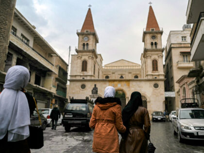 Women walk in Farhat Square outside the Maronite Cathedral of Saint Elijah (Mar Elias) in