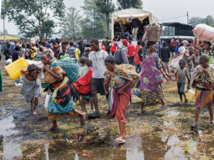 Congolese refugees fleeing ongoing clashes in eastern Democratic Republic of Congo carry t