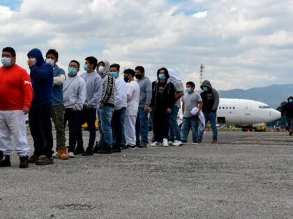 Guatemalan migrants deported from the United States, queue upon their arrival at the Air F