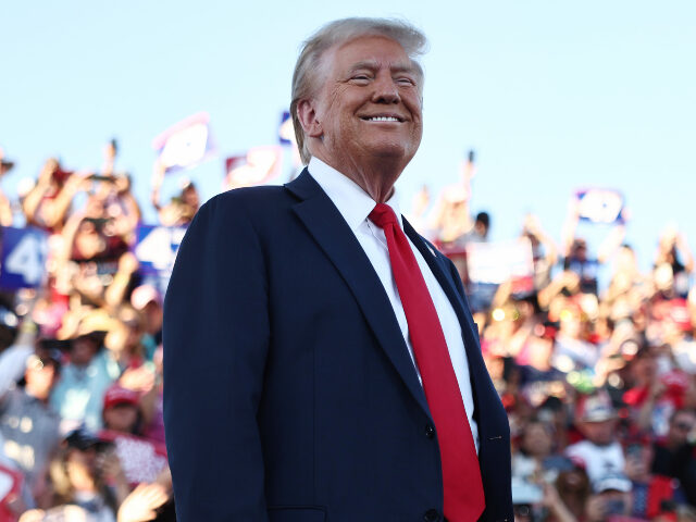 Republican presidential nominee, former U.S. President Donald Trump smiles while walking o