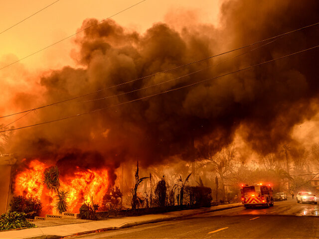 An apartment building burns during the Eaton fire in the Altadena area of Los Angeles coun